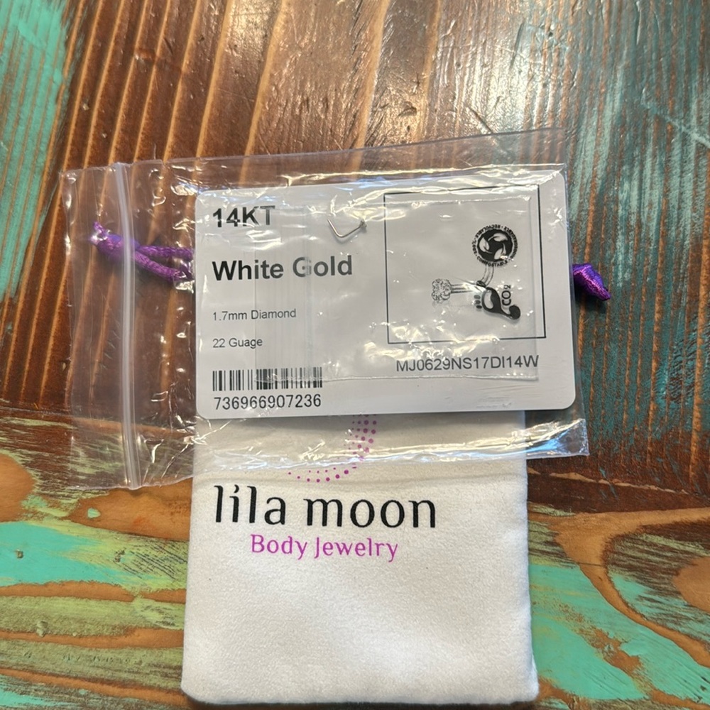 New in sealed package! 14kt white gold  1.7 mm Diamond nose ring. 22 guage